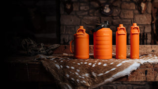 Girl wearing camo holding Grizzly Water Bottle in the Winter