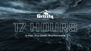 Image of dark, stormy waters. There are waves with whitecaps and very dark, stormy skies above. The Grizzly Coolers logo is in the center above the title "17 Hours" "A man. In a cooler. In a hurricane." 